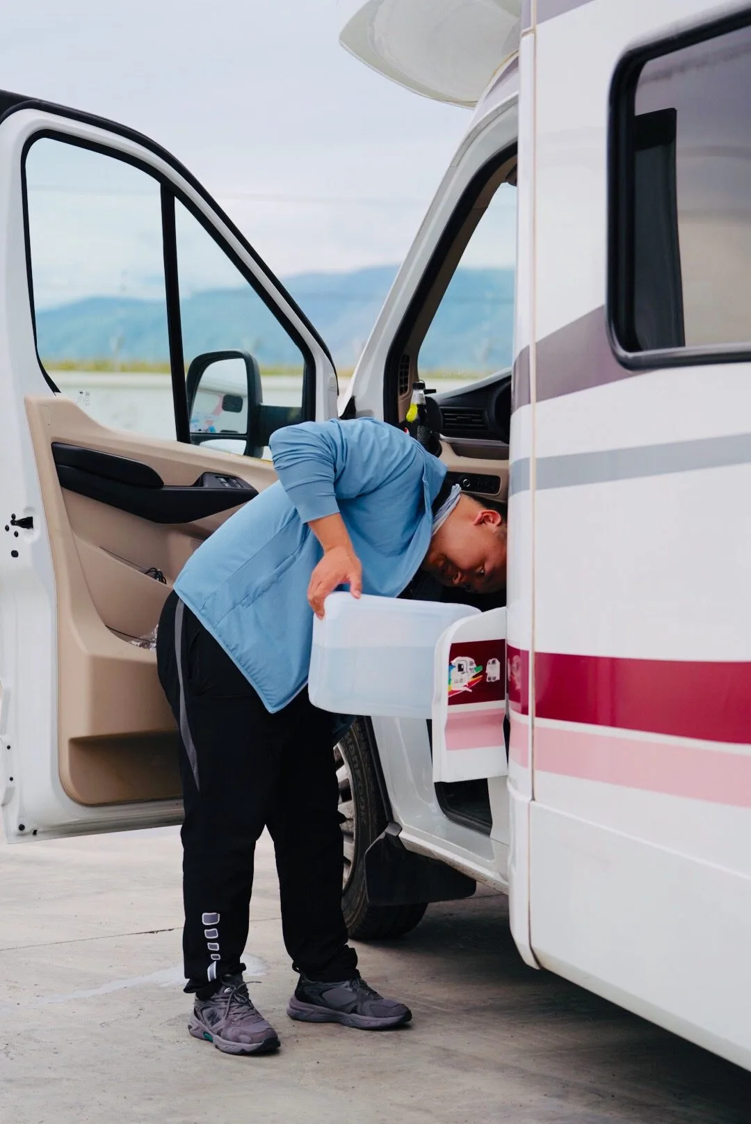 RV2GO staff performing a thorough pre-rental vehicle inspection on a SAIC Maxus campervan